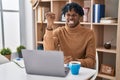 Young african man with dreadlocks working using computer laptop angry and mad raising fist frustrated and furious while shouting Royalty Free Stock Photo