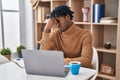 Young african man with dreadlocks working using computer laptop tired rubbing nose and eyes feeling fatigue and headache Royalty Free Stock Photo