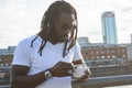 young African man eating ice cream at sunset in Buenos Aires