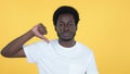 Casual African Man Gesturing Thumbs Down Isolated on Yellow Background Royalty Free Stock Photo