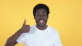 Casual African Man Gesturing Thumbs Up Isolated on Yellow Background Royalty Free Stock Photo