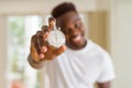 Young african man holding silver retro stopwatch counting time