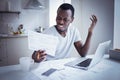 Young african man looking at bill, frustrated about high taxes, having problems with debt Royalty Free Stock Photo