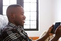Young african man looking at digital tablet Royalty Free Stock Photo