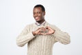 young african man makes hand heart shape using fingers isolated white background. Positive human emotions, facial Royalty Free Stock Photo