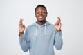 Young african man making a wish isolated on white background. Royalty Free Stock Photo