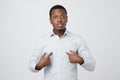 Young african man pointing at himself, making excuses or verbally defending, Royalty Free Stock Photo