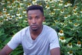 Young african man portrait flower background rural lifestyle garden Royalty Free Stock Photo