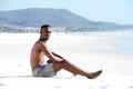 Young african man sitting alone at beach Royalty Free Stock Photo