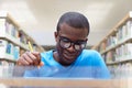 Young african man studying in library Royalty Free Stock Photo