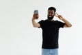 Young african man taking selfie with okay gesture isolated on gray background Royalty Free Stock Photo