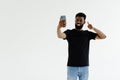 Young african man taking selfie with okay gesture isolated on gray background Royalty Free Stock Photo