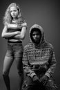 Young African man with teenage girl together against gray background Royalty Free Stock Photo