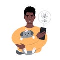 young african man with a tiny dog searching for veterinarian online from smartphone. Royalty Free Stock Photo