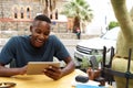 Young african man using digital tablet at a cafe Royalty Free Stock Photo