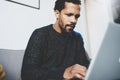 Young African man using laptop while sitting at his modern coworking place.Concept of full concentration.Blurred Royalty Free Stock Photo