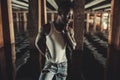 Young African man stands in water under bridge Royalty Free Stock Photo