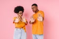 Young african man and woman showing stop gesture at camera together isolated Royalty Free Stock Photo