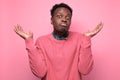 Young african man in yellow clothes shrugging shoulders Royalty Free Stock Photo