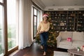 Young african mixed race woman dancing, celebrating Christmas.