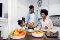 African parents with daughter enjoying breakfast at home