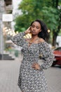 Young African Pensive Woman Stands In City Against Background Of Street
