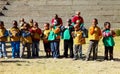 Young African Preschool children doing an egg and spoon race on the playground