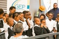 Young African Preschool kids singing songs outside local grocery shop