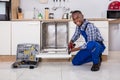 Repairman Fixing Dishwasher Royalty Free Stock Photo