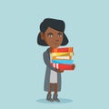 Young african student holding pile of books. Royalty Free Stock Photo