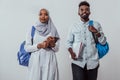 Young African students couple walking woman wearing traditional Sudan Muslim hijab clothes business team isolated on Royalty Free Stock Photo