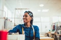 African textile worker sewing on production line