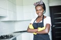 Young african woman with arms crossed before cleaning in the kitchen Royalty Free Stock Photo