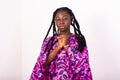 Portrait african woman with braids keeping fists on chest, sad Royalty Free Stock Photo