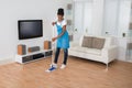 Woman Cleaning Floor In Living Room Royalty Free Stock Photo