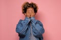 Young african woman covering face with hands hiding her emotions from everybody. Royalty Free Stock Photo
