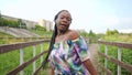 Young african woman dancing gait walking across the bridge