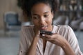 Young african woman dictating audio message on cellphone. Royalty Free Stock Photo