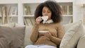 Young African Woman Drinking Tea on Sofa