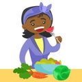 Young african woman eating healthy vegetable salad