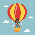 Young african woman flying in hot air balloon.