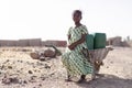 Young African Woman Gathering Fresh Water in a rural village