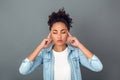 Young african woman on grey wall studio casual daily lifestyle relaxed Royalty Free Stock Photo