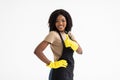 Young african woman hausewife cleaning with yellow gloves giving a thumbs-up isolated on white background. Happy cleaner having Royalty Free Stock Photo