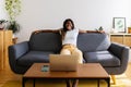 Young african woman having fun watching online videos on laptop at home Royalty Free Stock Photo