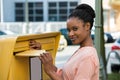 Woman Inserting Letter In Mailbox Royalty Free Stock Photo