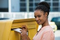 Woman Inserting Letter In Mailbox Royalty Free Stock Photo