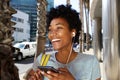 Young african woman listening to music on mobile phone Royalty Free Stock Photo