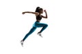 Young african woman running or jogging isolated on white studio background. Royalty Free Stock Photo