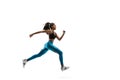 Young african woman running or jogging isolated on white studio background. Royalty Free Stock Photo